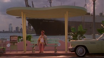 Movie still from “The Birdcage” (1996), directed by Mike Nichols – A man sitting on a bench next to the ocean; Extreme Wide shot, Low angle