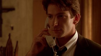 Movie still from “The Birdcage” (1996), directed by Mike Nichols – A man in a suit talking on a phone; Close Up shot, Low angle