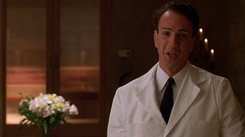 Movie still from “The Birdcage” (1996), directed by Mike Nichols – A man wearing a white suit and tie; Close Up shot, Low angle