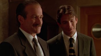 Movie still from “The Birdcage” (1996), directed by Mike Nichols – Two men in suits standing next to each other; Close Up shot, Low angle