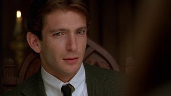 Movie still from “The Birdcage” (1996), directed by Mike Nichols – A person wearing a suit and tie; Close Up shot, Over the shoulder angle