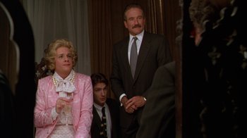 Movie still from “The Birdcage” (1996), directed by Mike Nichols – Two men and a woman sitting in front of a curtain; Medium shot, Over the shoulder angle