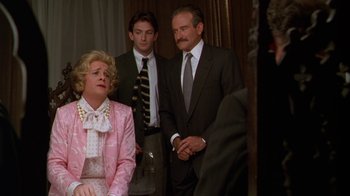 Movie still from “The Birdcage” (1996), directed by Mike Nichols – A woman and two men in suits and ties; Medium shot, Over the shoulder angle