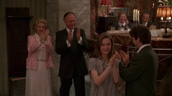 Movie still from “The Birdcage” (1996), directed by Mike Nichols – A group of people applauding a woman in a dress; Medium shot, Over the shoulder angle
