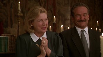 Movie still from “The Birdcage” (1996), directed by Mike Nichols – An older woman clasping her hands in front of a man; Close Up shot, Low angle