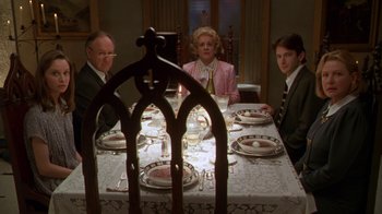 Movie still from “The Birdcage” (1996), directed by Mike Nichols – A group of people sitting at a dinner table; Medium shot, High angle