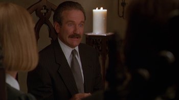 Movie still from “The Birdcage” (1996), directed by Mike Nichols – A man sitting in front of a lit candle; Close Up shot, Over the shoulder angle