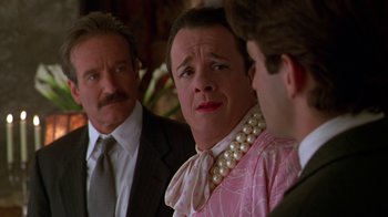Movie still from “The Birdcage” (1996), directed by Mike Nichols – A man in a pink shirt and a man in a black suit and a man in a white shirt and a man in a pink shirt and a; Close Up shot, Over the shoulder angle