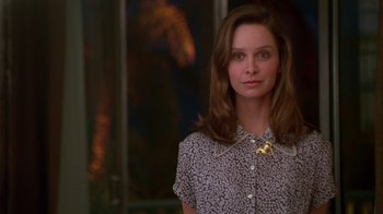 Movie still from “The Birdcage” (1996), directed by Mike Nichols – A woman in a white and black shirt is standing in front of a window; Close Up shot, Low angle