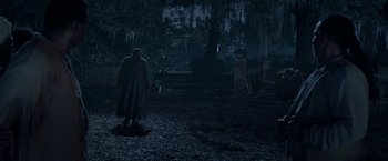 Movie still from “The Birth of a Nation” (2016), directed by Nate Parker – A man standing in the middle of a dark forest at night; Extreme Wide shot, High angle