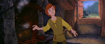 Movie still from “The Black Cauldron” (1985), directed by Ted Berman – A man in a yellow shirt is standing in front of a fireplace; Medium shot, High angle