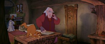Movie still from “The Black Cauldron” (1985), directed by Ted Berman – An old man sitting at a table with a cat on it; Medium shot, Over the shoulder angle