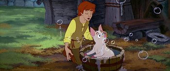 Movie still from “The Black Cauldron” (1985), directed by Ted Berman – A man and a pig in a tub of bubbles; Medium shot, High angle
