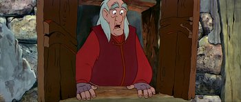 Movie still from “The Black Cauldron” (1985), directed by Ted Berman – An old man with long white hair and a red shirt; Medium shot, Low angle