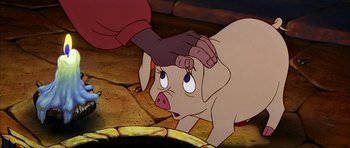 Movie still from “The Black Cauldron” (1985), directed by Ted Berman – A cartoon of a pig being petted by a person; Close Up shot, High angle