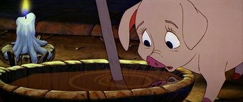Movie still from “The Black Cauldron” (1985), directed by Ted Berman – A cartoon of a piglet drinking water from a bowl; Close Up shot, High angle