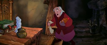 Movie still from “The Black Cauldron” (1985), directed by Ted Berman – An old man holding a piece of paper in his hand; Medium shot, Over the shoulder angle