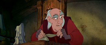 Movie still from “The Black Cauldron” (1985), directed by Ted Berman – An old man is tying a bow tie in a cartoon; Close Up shot, Over the shoulder angle