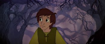 Movie still from “The Black Cauldron” (1985), directed by Ted Berman – A cartoon picture of a young man looking sad; Medium shot, High angle