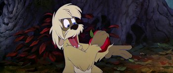 Movie still from “The Black Cauldron” (1985), directed by Ted Berman – A dog holding an apple in his mouth; Close Up shot, Low angle