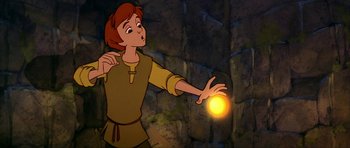 Movie still from “The Black Cauldron” (1985), directed by Ted Berman – A cartoon picture of a man holding an object in his hand; Medium shot, Low angle