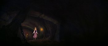 Movie still from “The Black Cauldron” (1985), directed by Ted Berman – A woman standing in the dark in front of a cave; Wide shot, Low angle