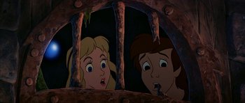 Movie still from “The Black Cauldron” (1985), directed by Ted Berman – A couple of people that are in a cage; Close Up shot, Low angle