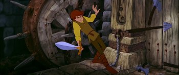 Movie still from “The Black Cauldron” (1985), directed by Ted Berman – A man holding a sword in his hand in a cave; Medium shot, High angle