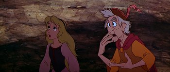 Movie still from “The Black Cauldron” (1985), directed by Ted Berman – A man and a woman looking at each other in front of a rock wall; Close Up shot, Over the shoulder angle