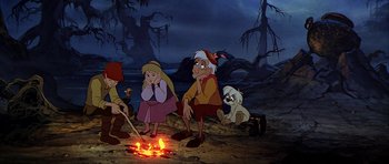 Movie still from “The Black Cauldron” (1985), directed by Ted Berman – A group of people sitting next to a fire pit; Wide shot, High angle