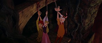 Movie still from “The Black Cauldron” (1985), directed by Ted Berman – A group of three people standing next to each other; Medium shot, Low angle