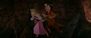 Movie still from “The Black Cauldron” (1985), directed by Ted Berman – A couple of people that are running in a cave; Medium shot, High angle