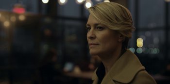 Movie still from “House of Cards” (2013), created by Beau Willimon – A person wearing a trench coat; Close Up shot, Low angle