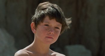 Movie still from “The Black Stallion” (1979), directed by Carroll Ballard – A young boy with brown hair and freckles; Close Up shot, Low angle