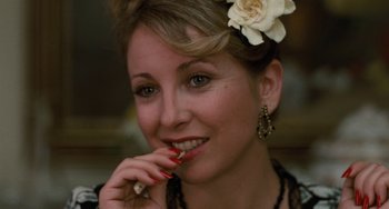 Movie still from “The Black Stallion” (1979), directed by Carroll Ballard – A beautiful woman with a flower in her hair; Close Up shot, Over the shoulder angle