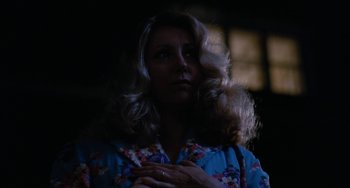 Movie still from “The Black Stallion” (1979), directed by Carroll Ballard – A woman with long blonde curly hair wearing a blue shirt; Close Up shot, Low angle