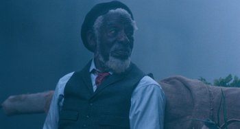 Movie still from “The Black Stallion” (1979), directed by Carroll Ballard – An older man wearing a hat and a vest; Medium shot, Low angle