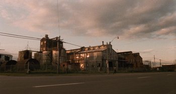 Movie still from “The Black Stallion” (1979), directed by Carroll Ballard – An old building is in the middle of a street; Extreme Wide shot, Low angle