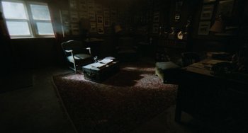 Movie still from “The Black Stallion” (1979), directed by Carroll Ballard – A living room filled with furniture and pictures on the wall; Wide shot, High angle