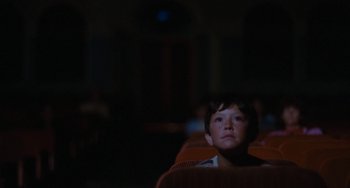 Movie still from “The Black Stallion” (1979), directed by Carroll Ballard – A young boy sitting in a chair looking up; Medium shot, Low angle