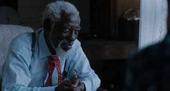 Movie still from “The Black Stallion” (1979), directed by Carroll Ballard – An older man wearing a red and white polka dot tie; Close Up shot, Over the shoulder angle