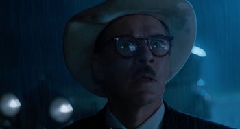 Movie still from “The Black Stallion” (1979), directed by Carroll Ballard – A person wearing a hat and glasses; Close Up shot, Low angle