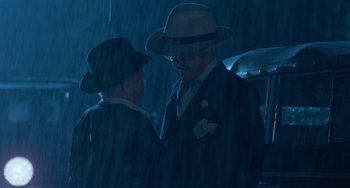 Movie still from “The Black Stallion” (1979), directed by Carroll Ballard – A man and a woman wearing hats in the rain; Medium shot, Over the shoulder angle