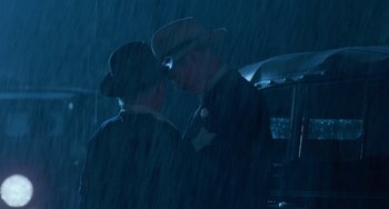 Movie still from “The Black Stallion” (1979), directed by Carroll Ballard – A couple of men standing next to each other in the rain; Medium shot, Low angle