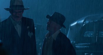 Movie still from “The Black Stallion” (1979), directed by Carroll Ballard – A man wearing a cowboy hat in the rain; Medium shot, Low angle