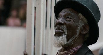 Movie still from “The Black Stallion” (1979), directed by Carroll Ballard – An older man with a beard and a hat; Close Up shot, Low angle