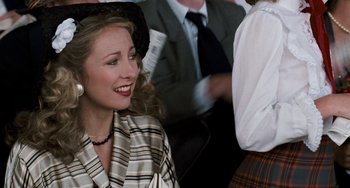 Movie still from “The Black Stallion” (1979), directed by Carroll Ballard – A woman in a hat is sitting in a crowd of people; Close Up shot, Over the shoulder angle