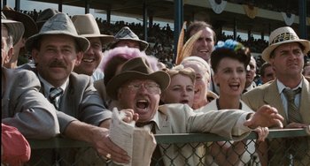 Movie still from “The Black Stallion” (1979), directed by Carroll Ballard – A group of people wearing hats and holding papers; Close Up shot, High angle