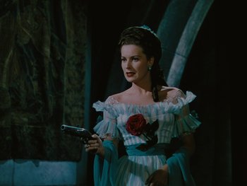 Movie still from “The Black Swan” (1942), directed by Henry King – A beautiful woman holding a gun while standing in a room; Medium shot, Over the shoulder angle