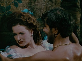 Movie still from “The Black Swan” (1942), directed by Henry King – A man and a woman are dancing together; Medium shot, Over the shoulder angle